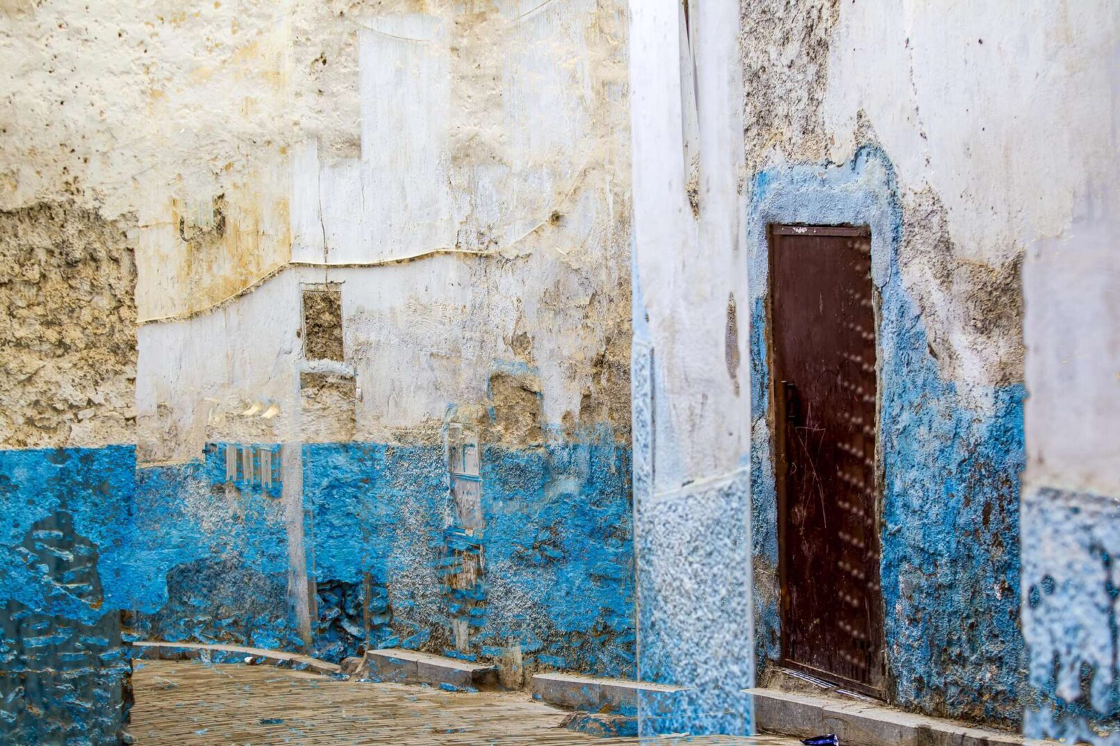 wall with white and turquoise paint and a door