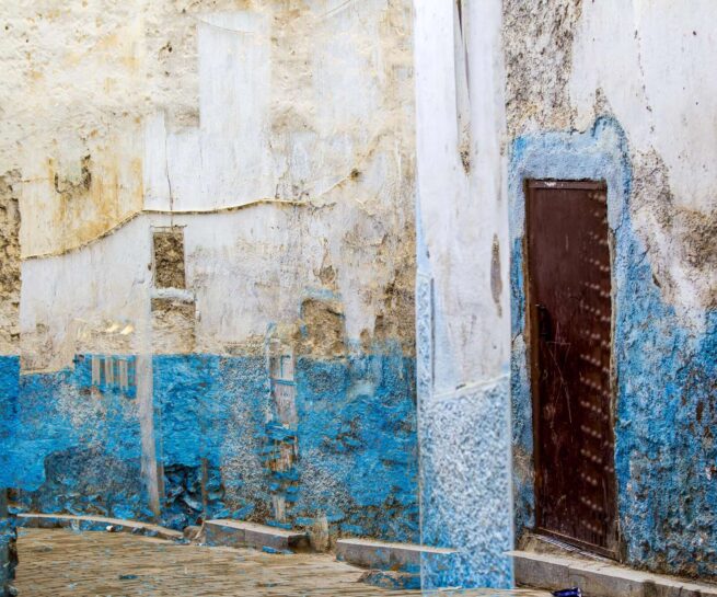 wall with white and turquoise paint and a door
