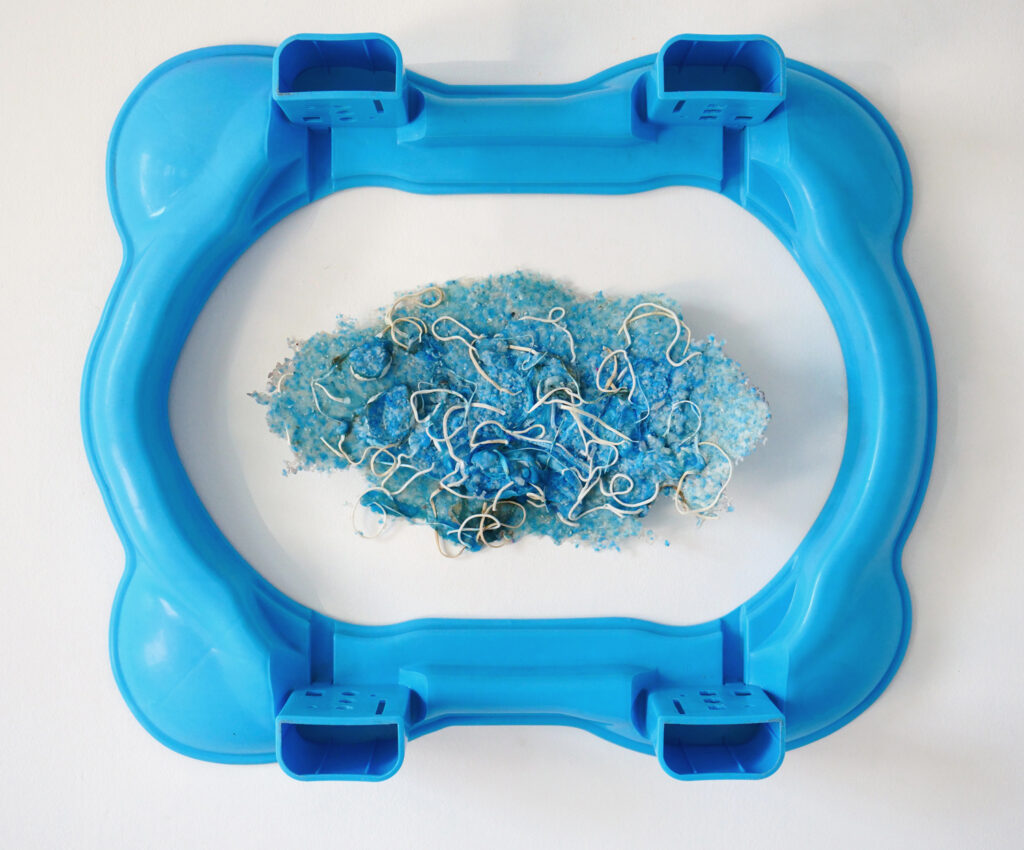 Blue plastic sculpture with a blue island in the middle